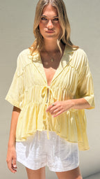 Women's tie-front peplum blouse with collared neckline