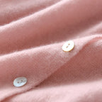 Women's asymmetric sweater with button detail