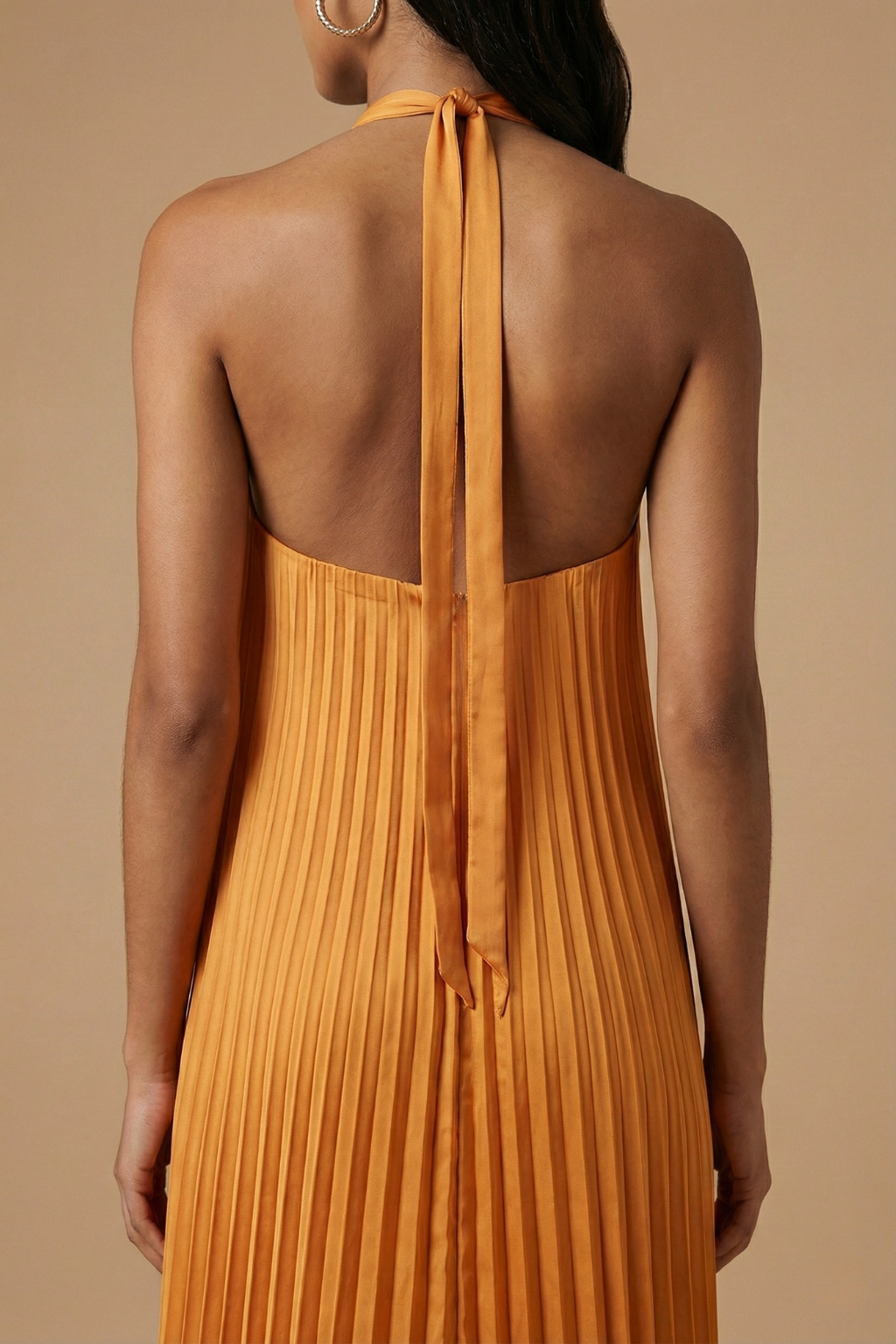 Women's halter neck maxi dress with open back and pleated skirt