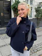 Women's jacket with stand-up collar and front fastening