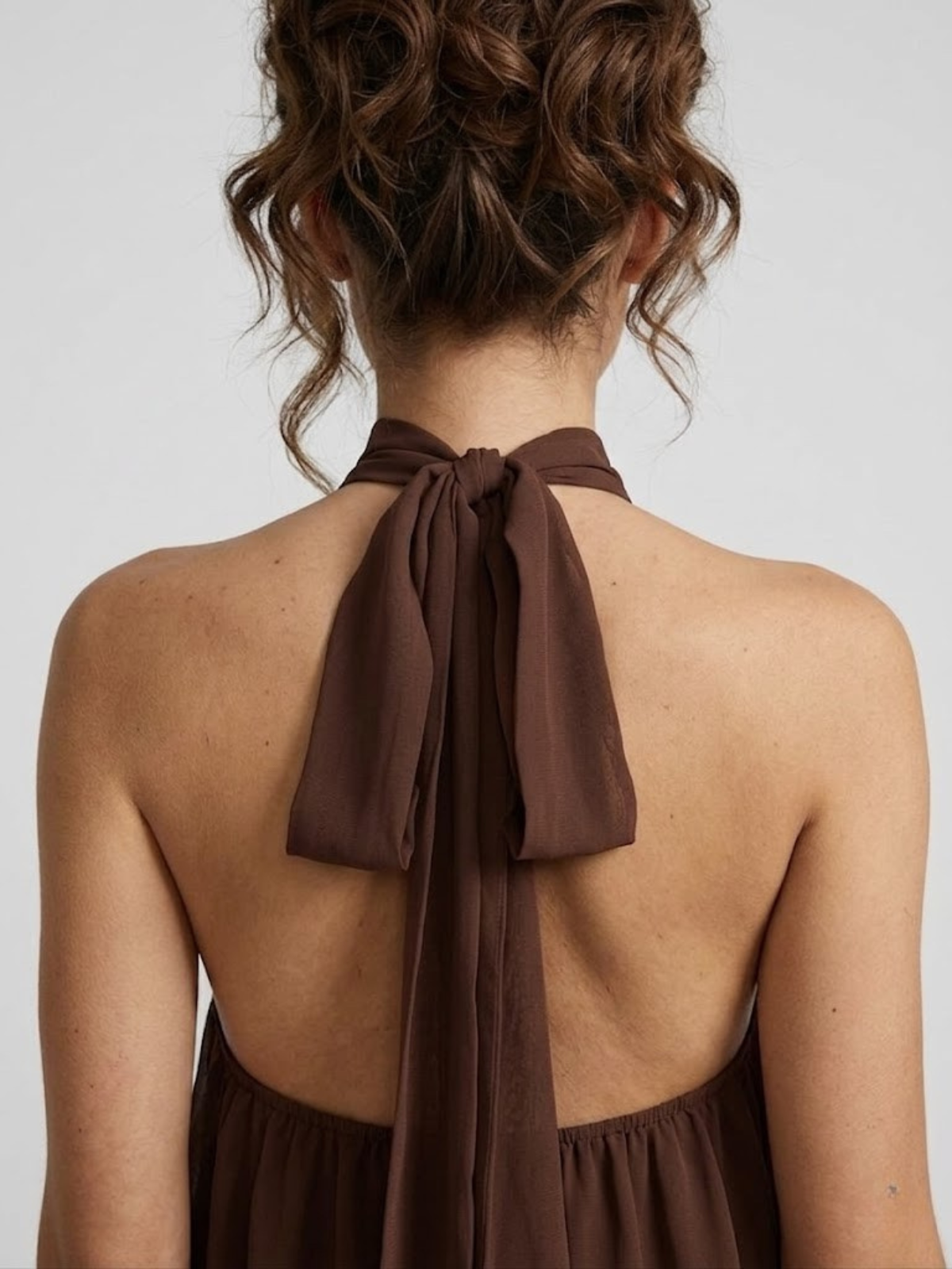 Women's mini dress with halter neck, open back and tiered ruffle hem