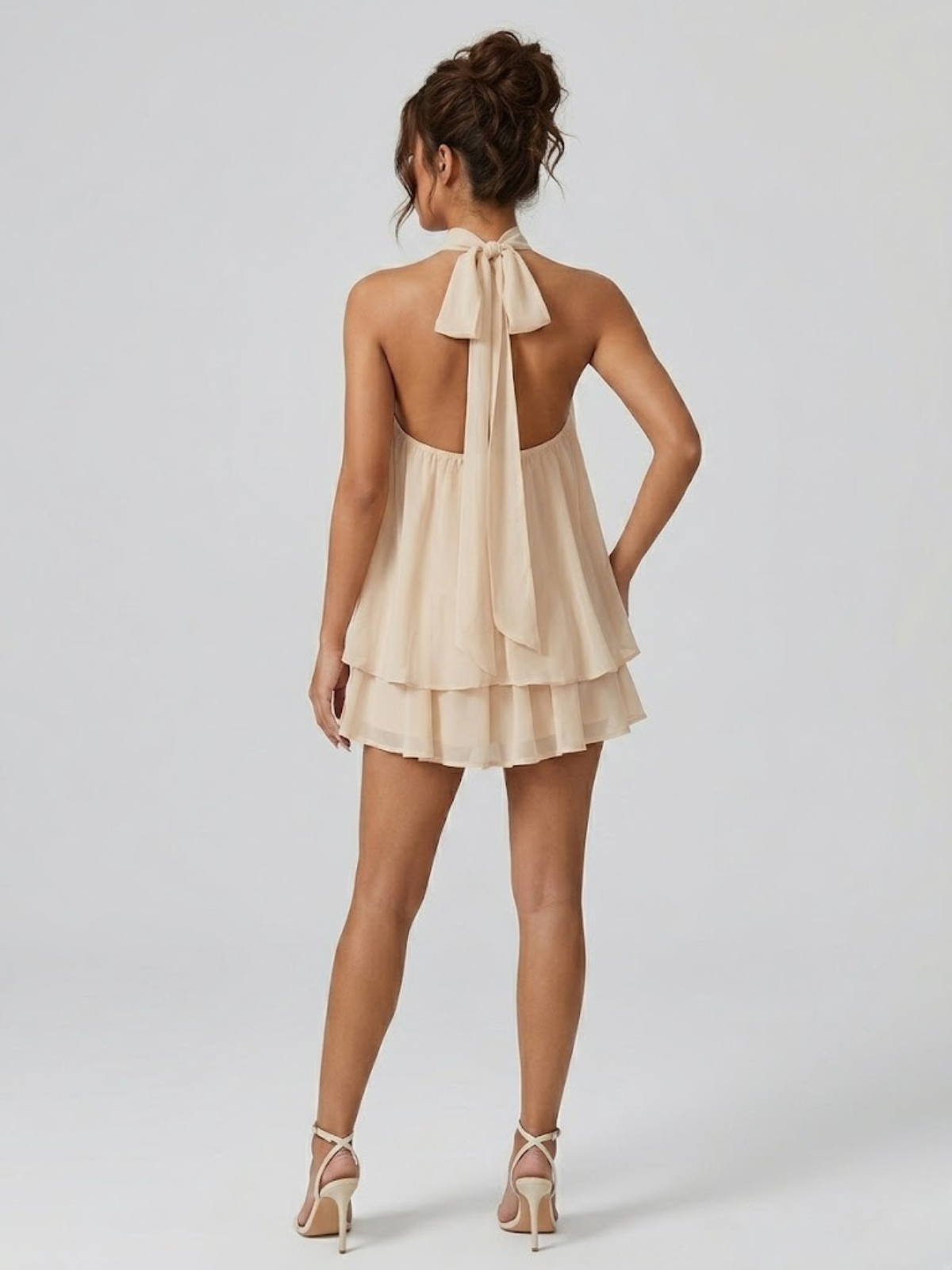 Women's mini dress with halter neck, open back and tiered ruffle hem