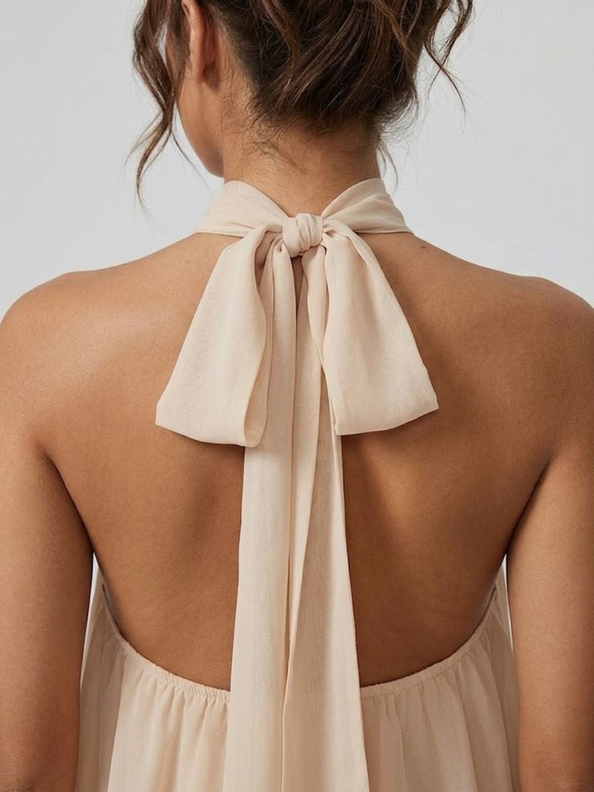 Women's mini dress with halter neck, open back and tiered ruffle hem