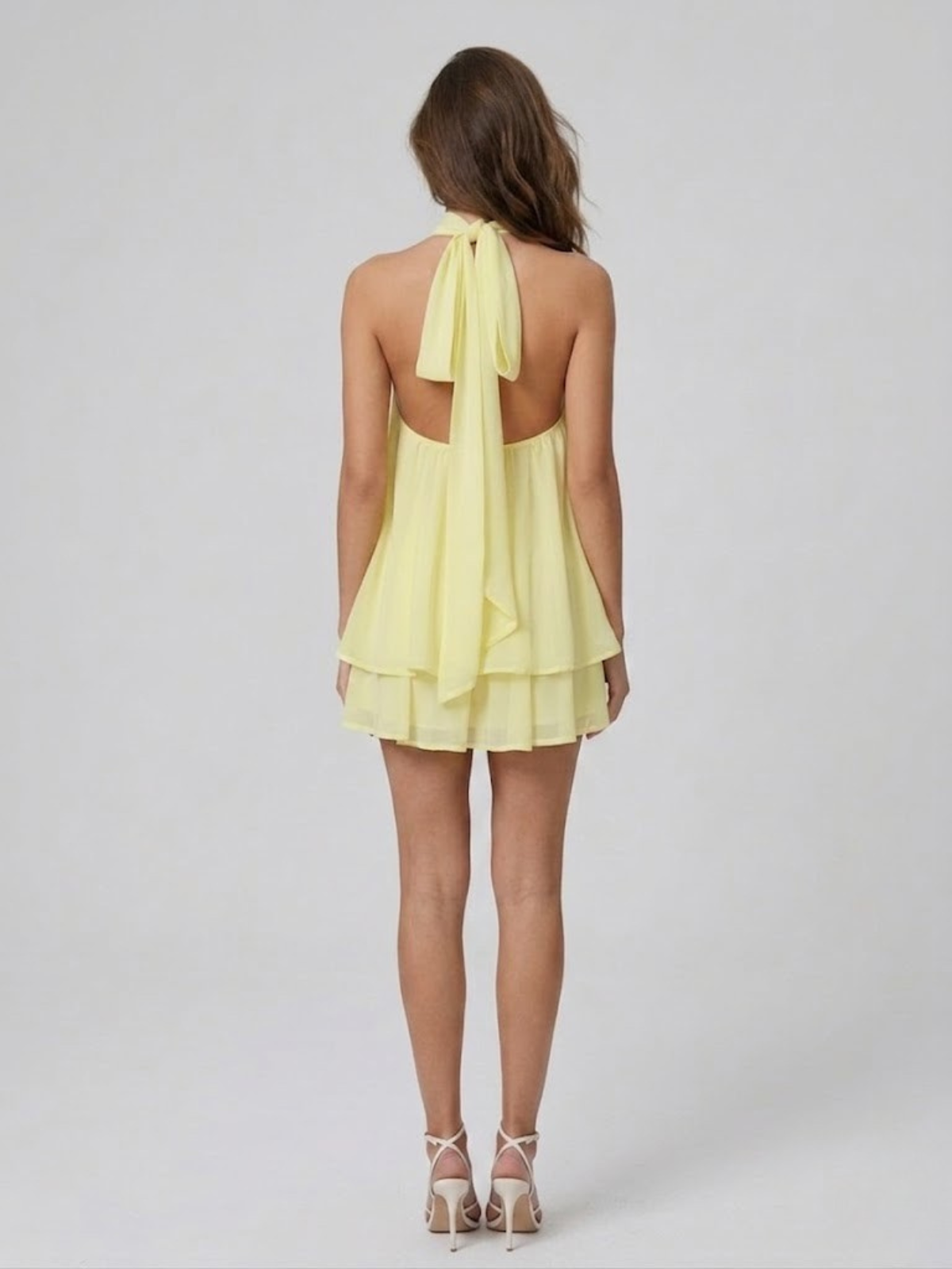 Women's mini dress with halter neck, open back and tiered ruffle hem