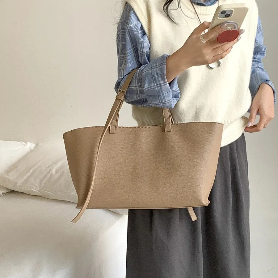 Women's structured open-top tote bag with adjustable crossbody strap