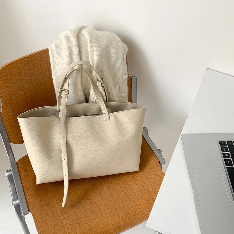 Women's structured open-top tote bag with adjustable crossbody strap